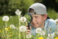 Girls looking at dandelions t...